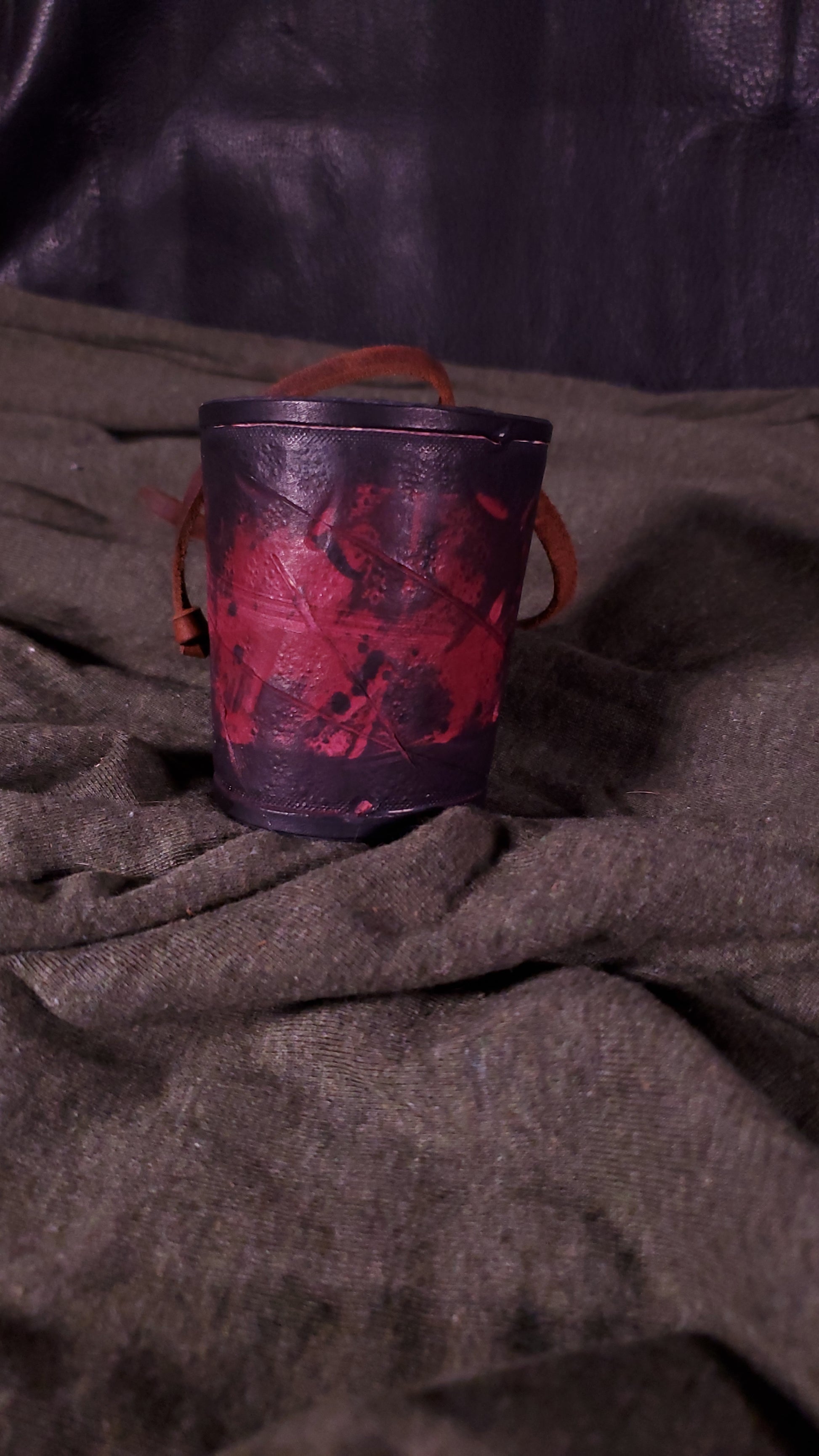Red small cuff with laces and battle damage