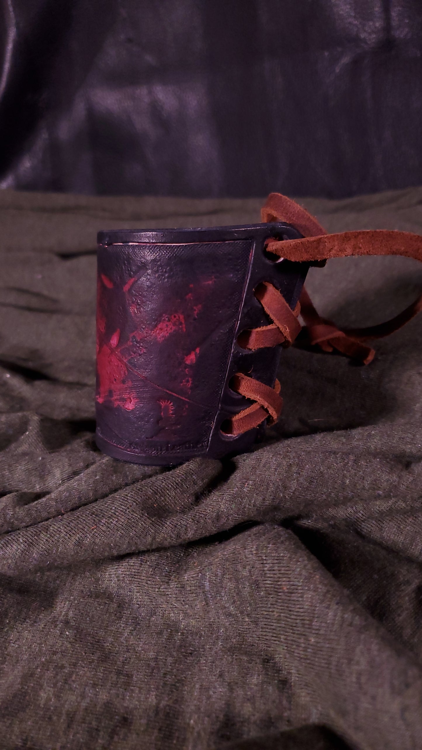 Red small cuff with laces and battle damage