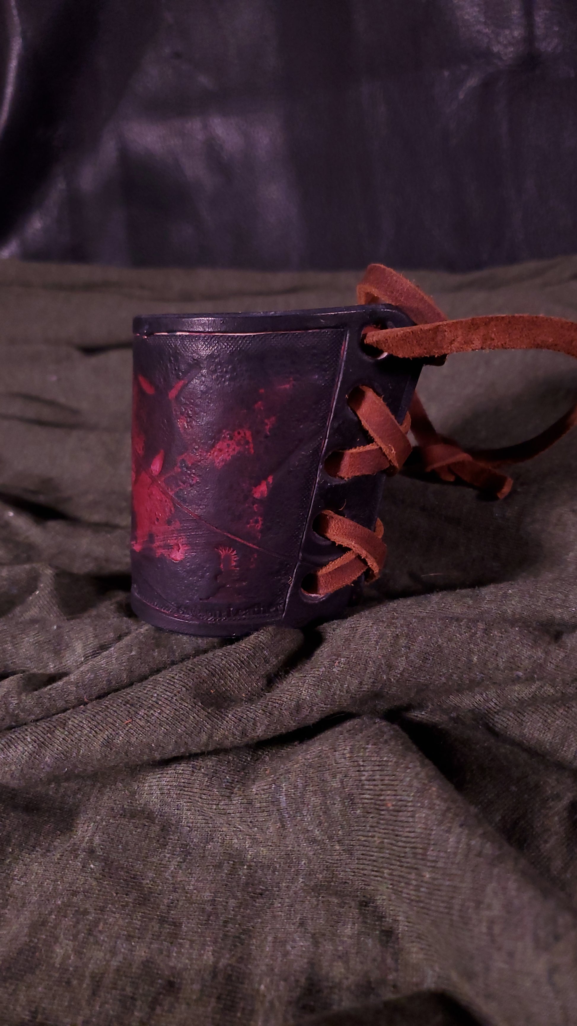 Red small cuff with laces and battle damage
