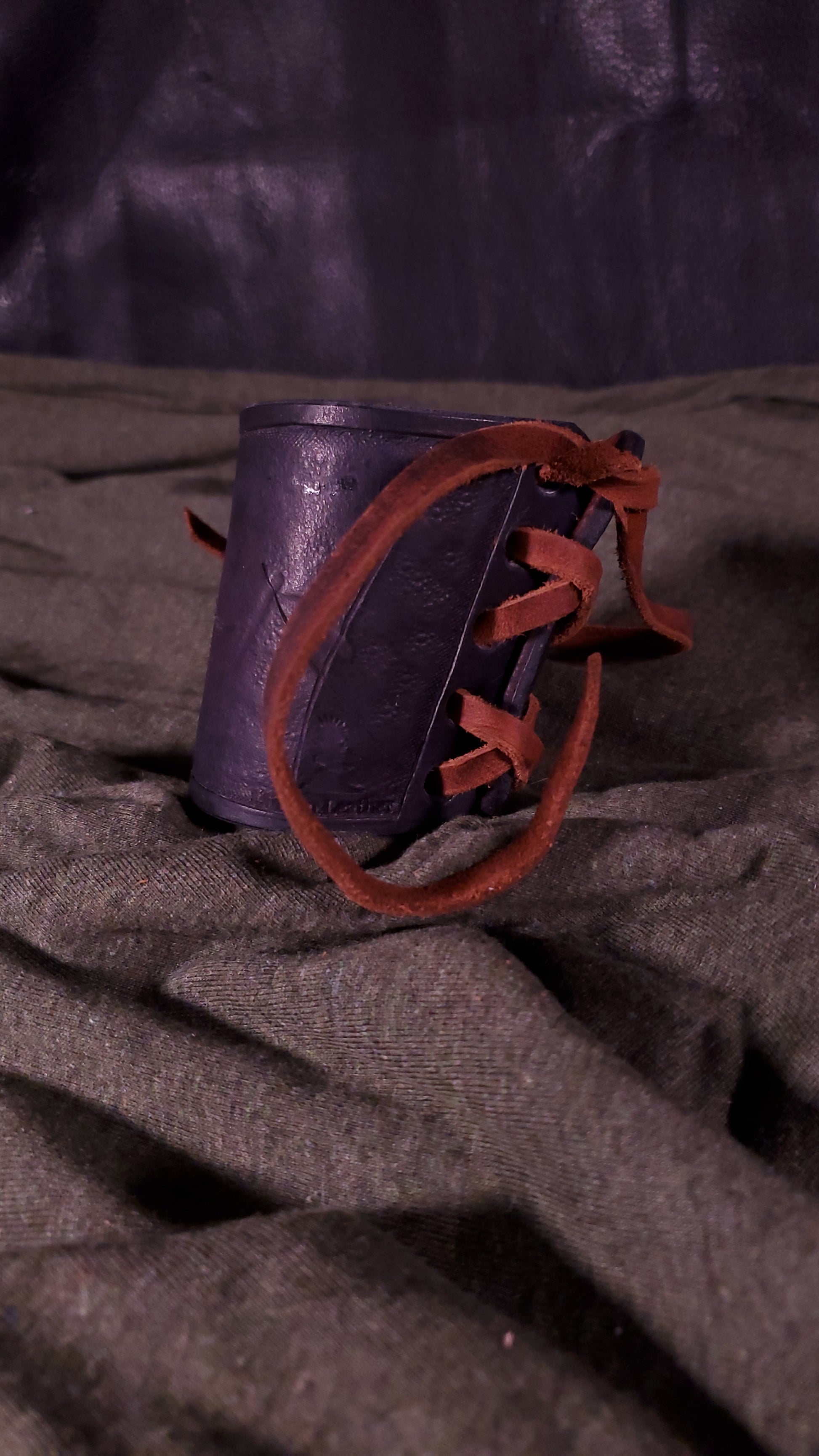 Black small cuff with laces and battle damage