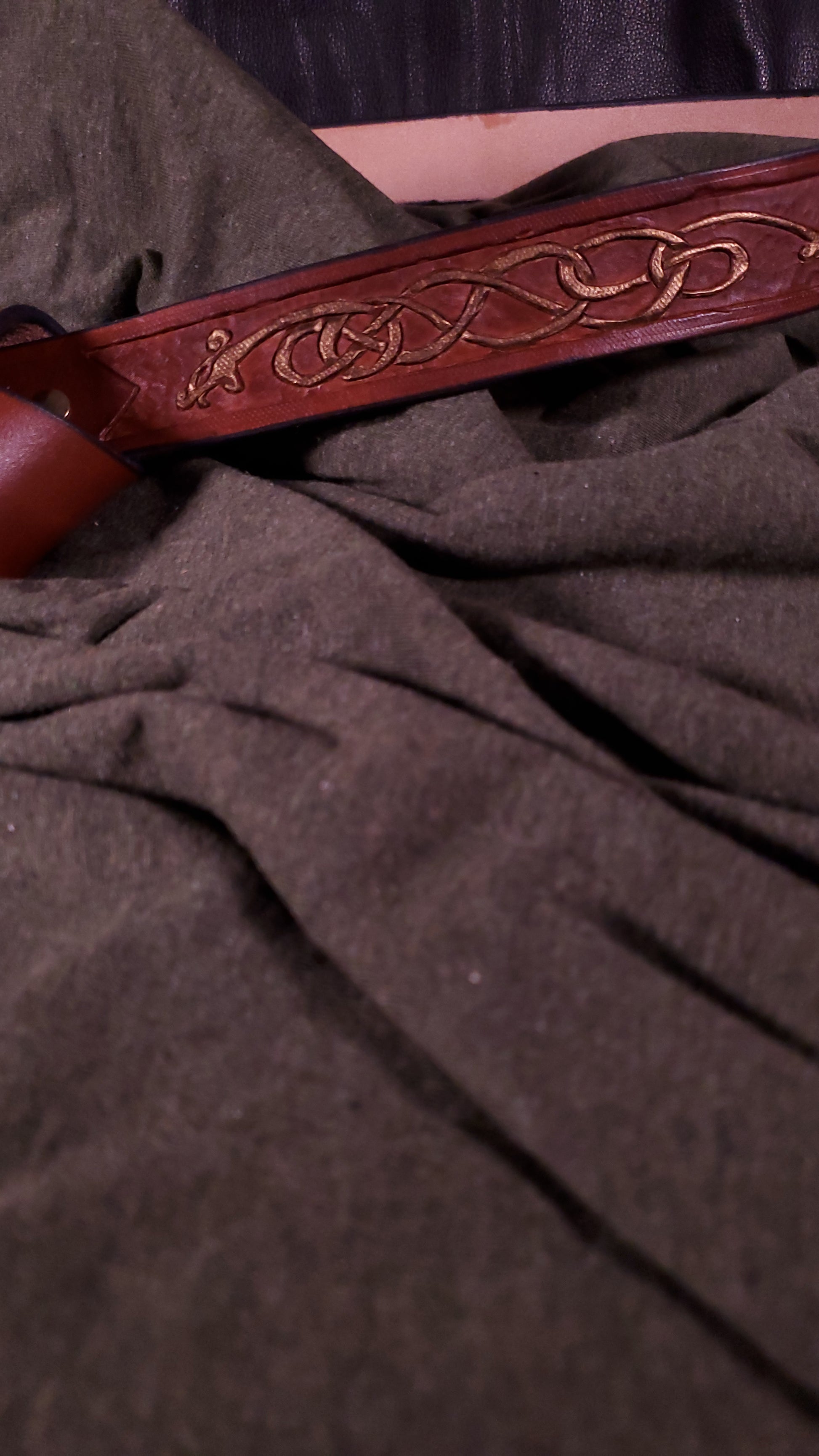Close up of the tooling at the top of the belt. The tooling is a viking styled serpent
