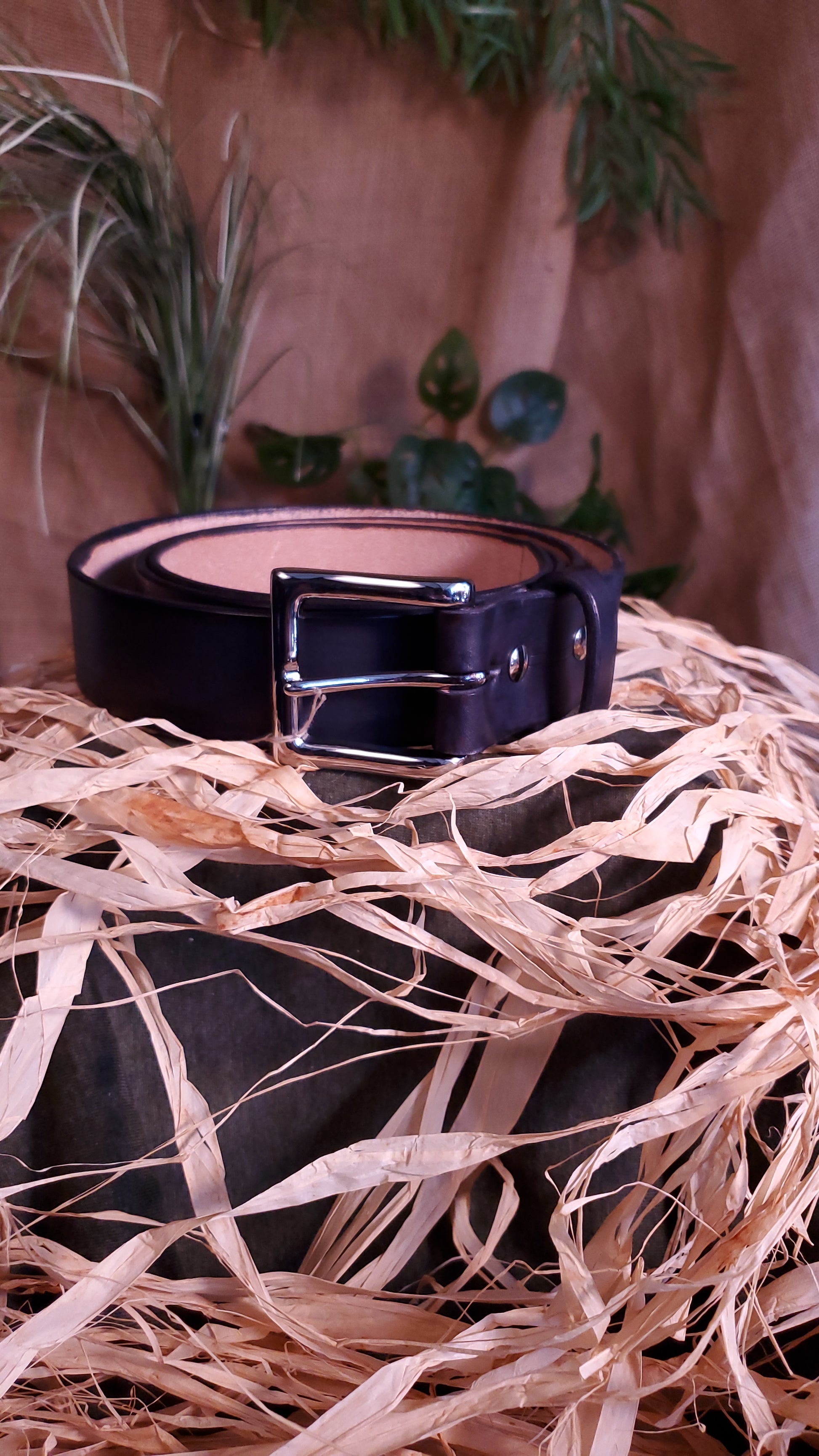 Black belt with a nickel buckle and matching hardware.