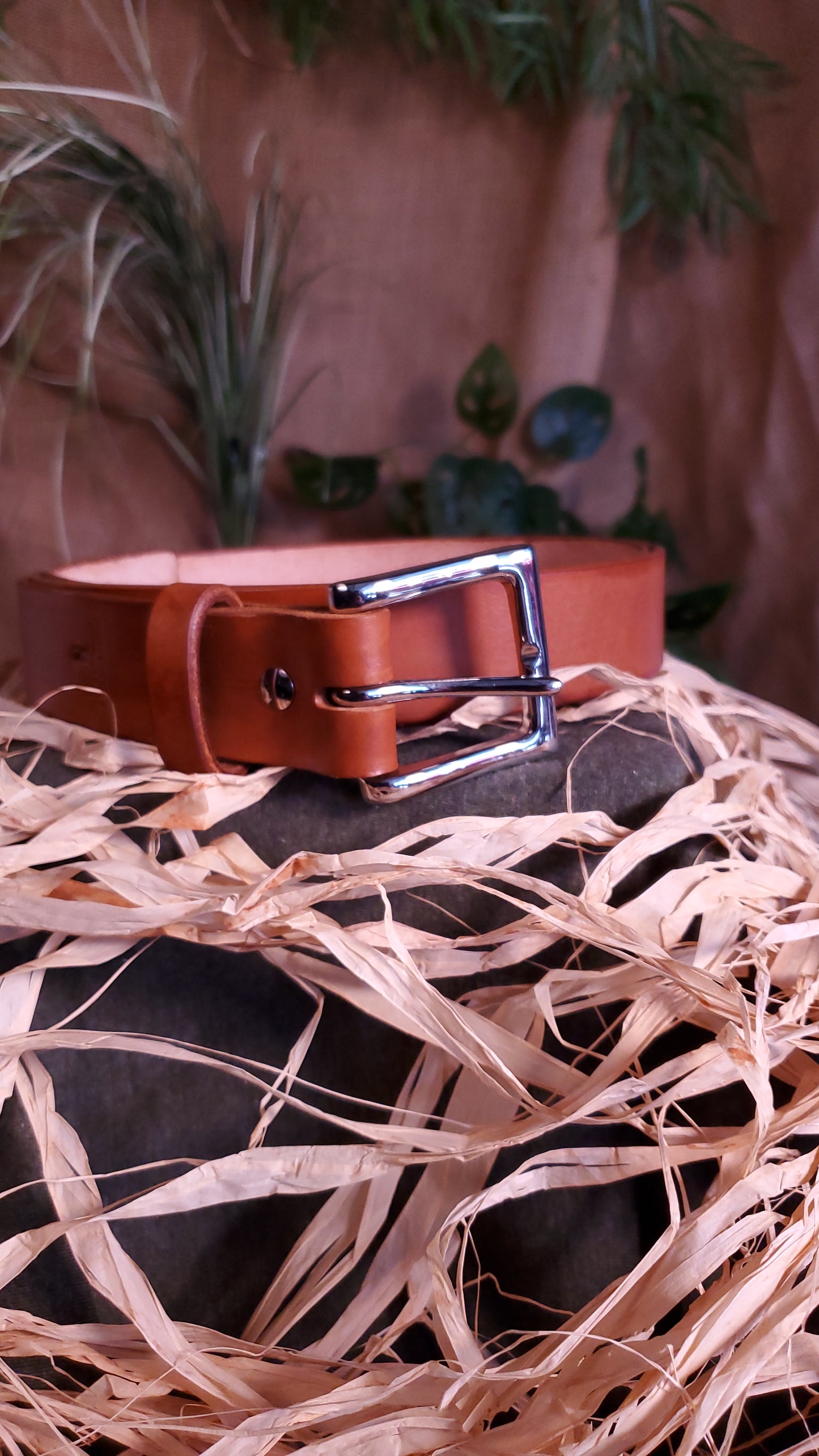 Brown colored belt with a nickel buckle and matching hardware.