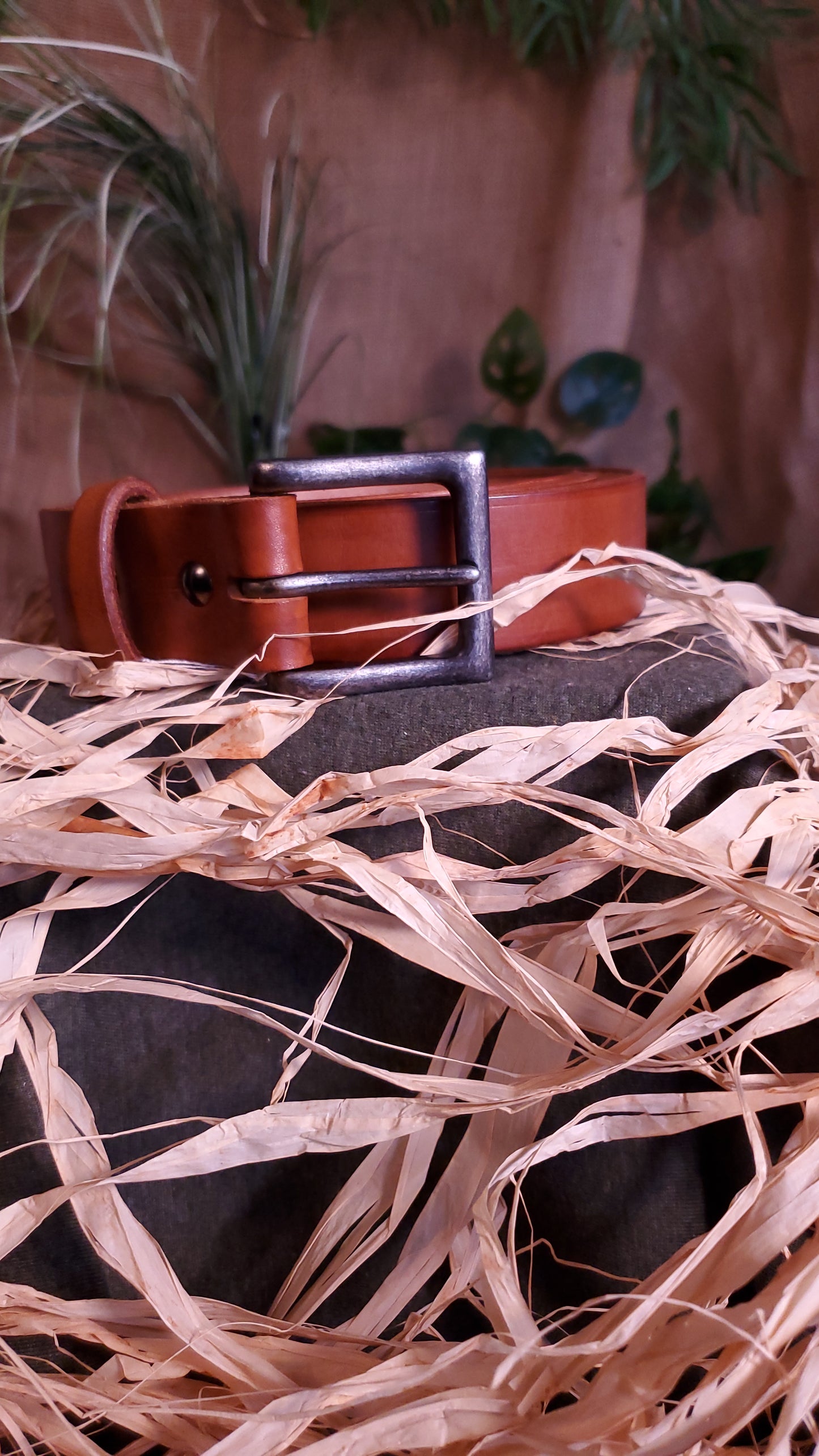 Brown colored belt with an antique nickel buckle and matching hardware.