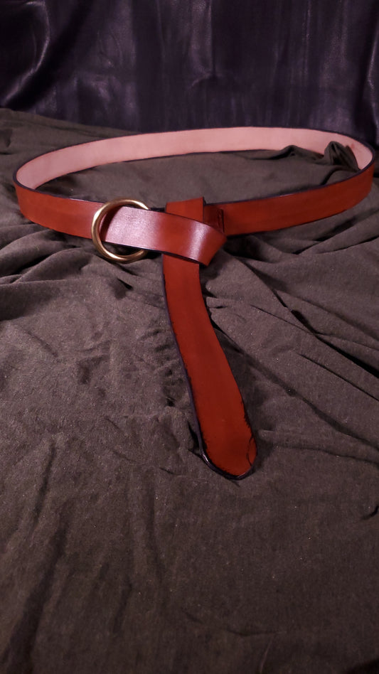 A simple plain belt with an O-ring buckle. The belt is tied in a classic medieval style
