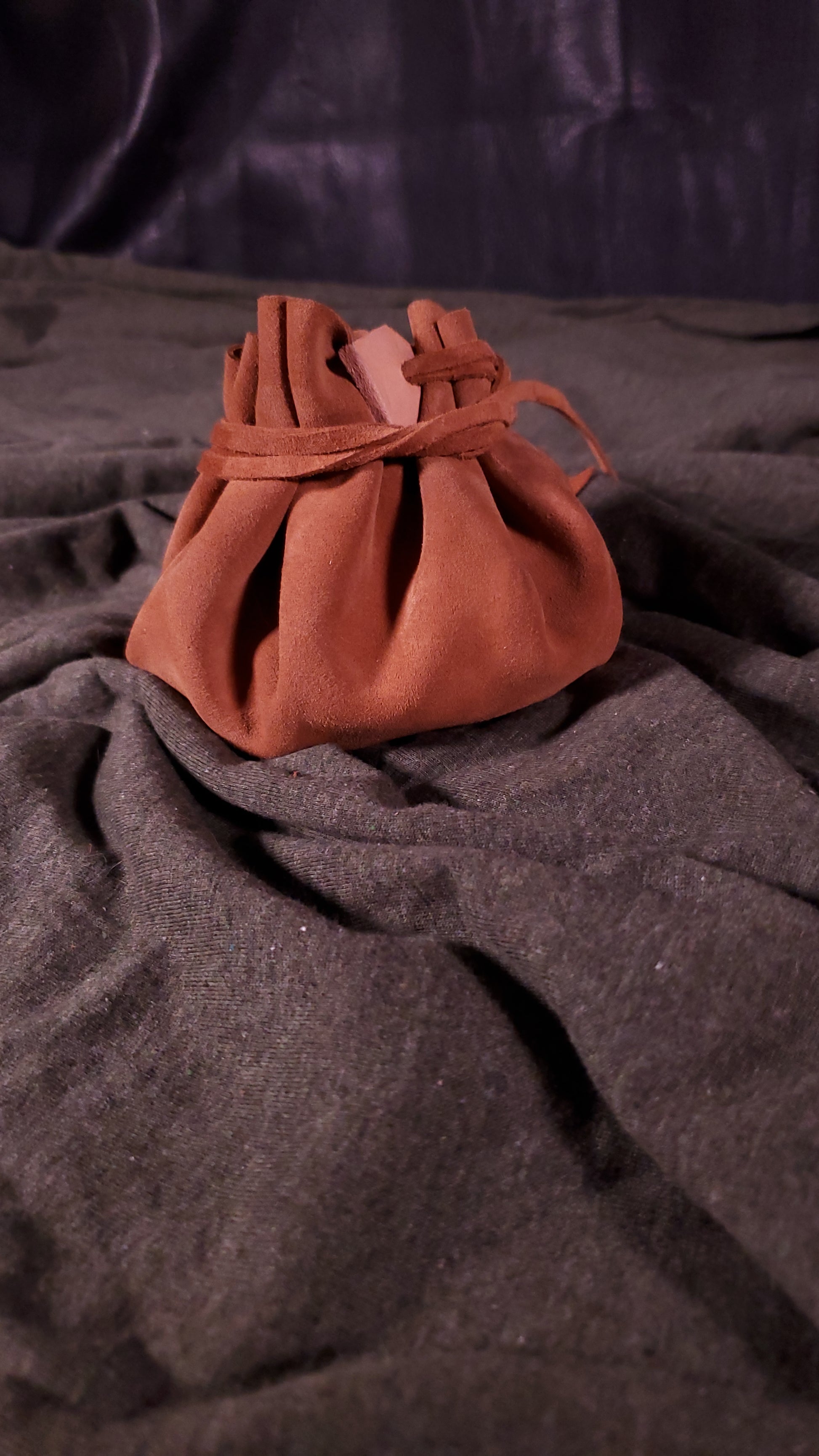 Closed suede dice bag in a light brown color