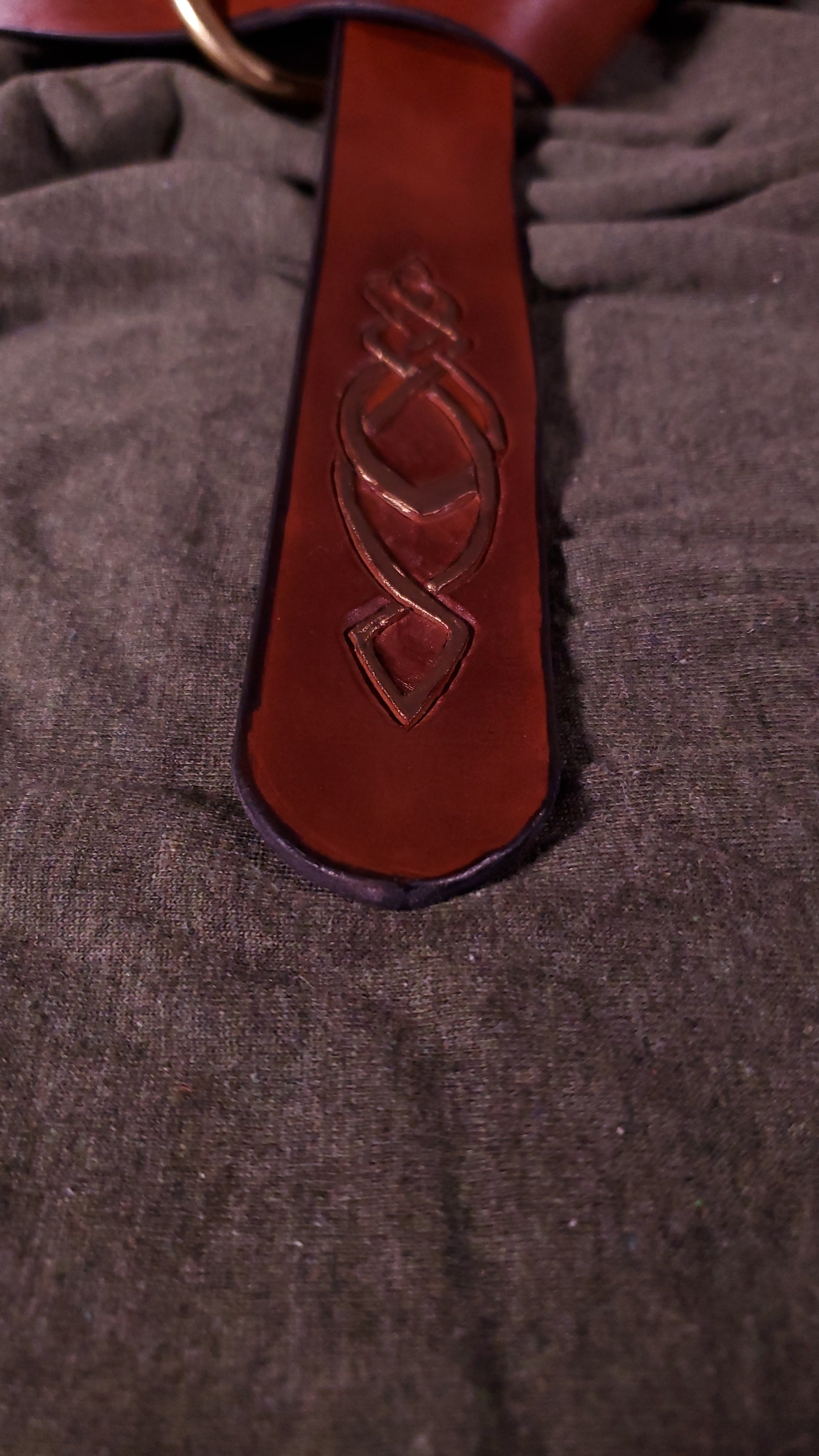 Close up of the tooling on the tip of the belt showing a celtic knot design