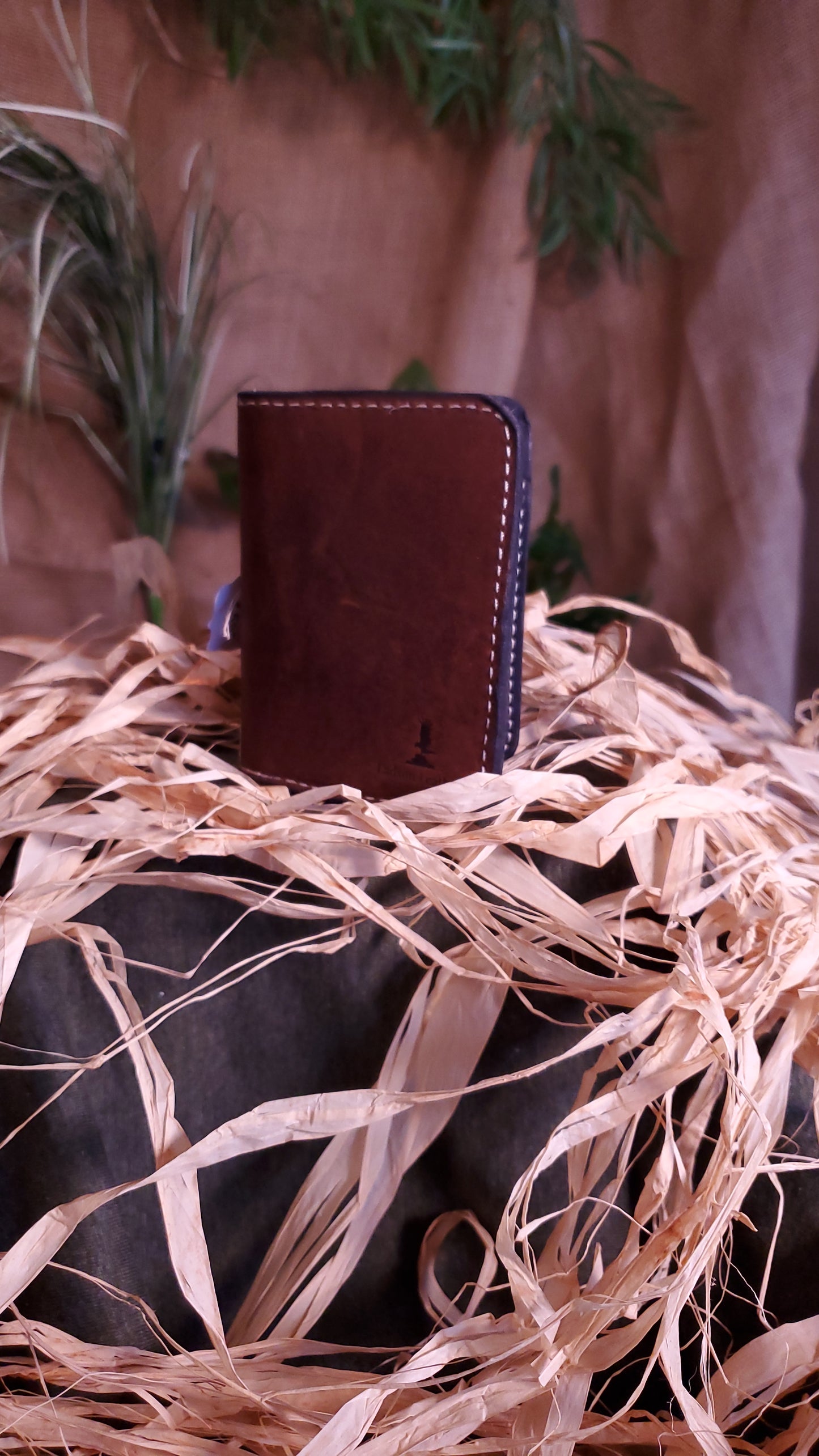 Bifold wallet in a rich brown color and cream colored stitching
