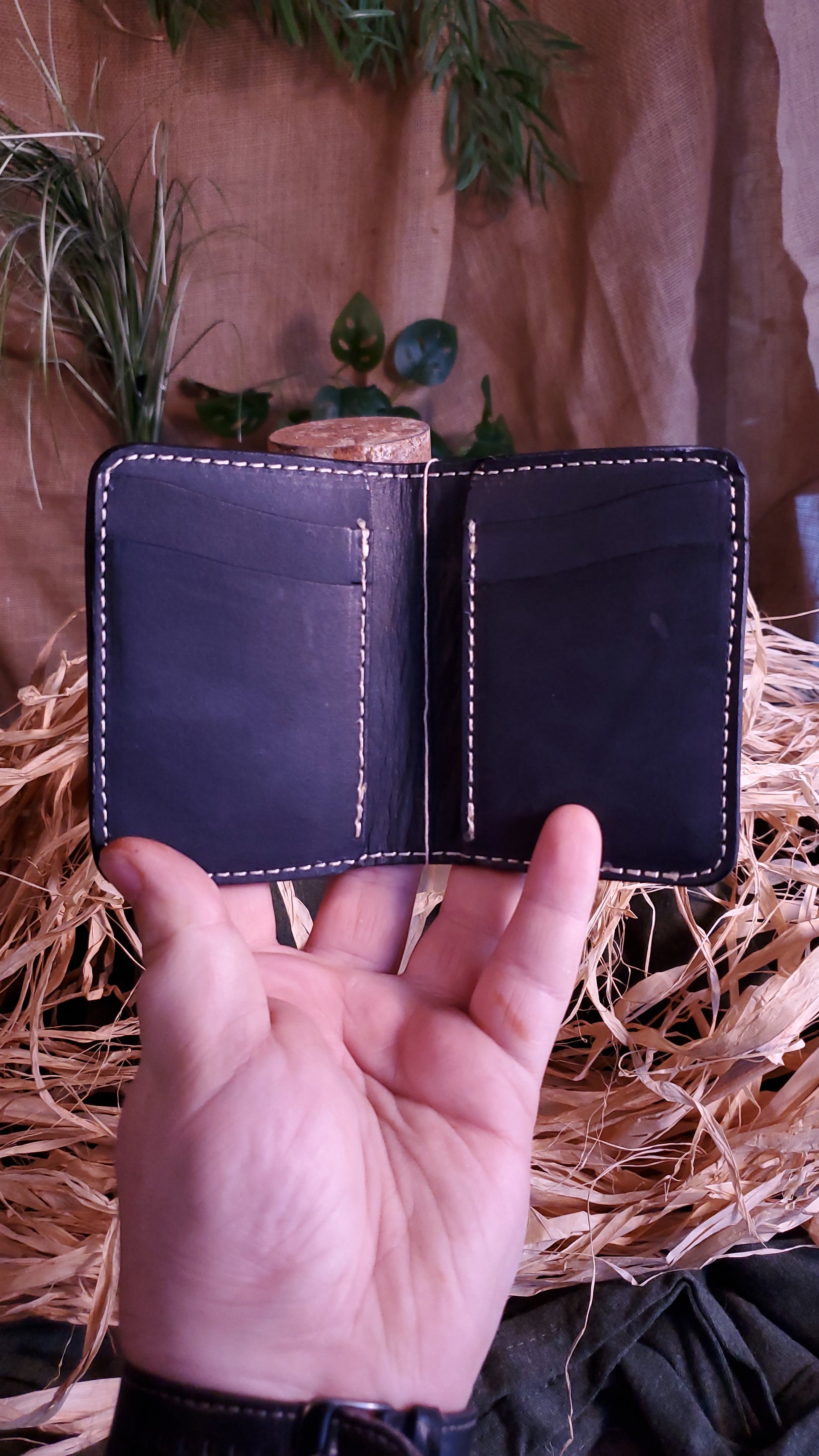 Interior of the Bi-fold style wallet, featuring 4 card slots, 2 on each side, as well as 2 hidden pockets behind the card slots, 1 on each side