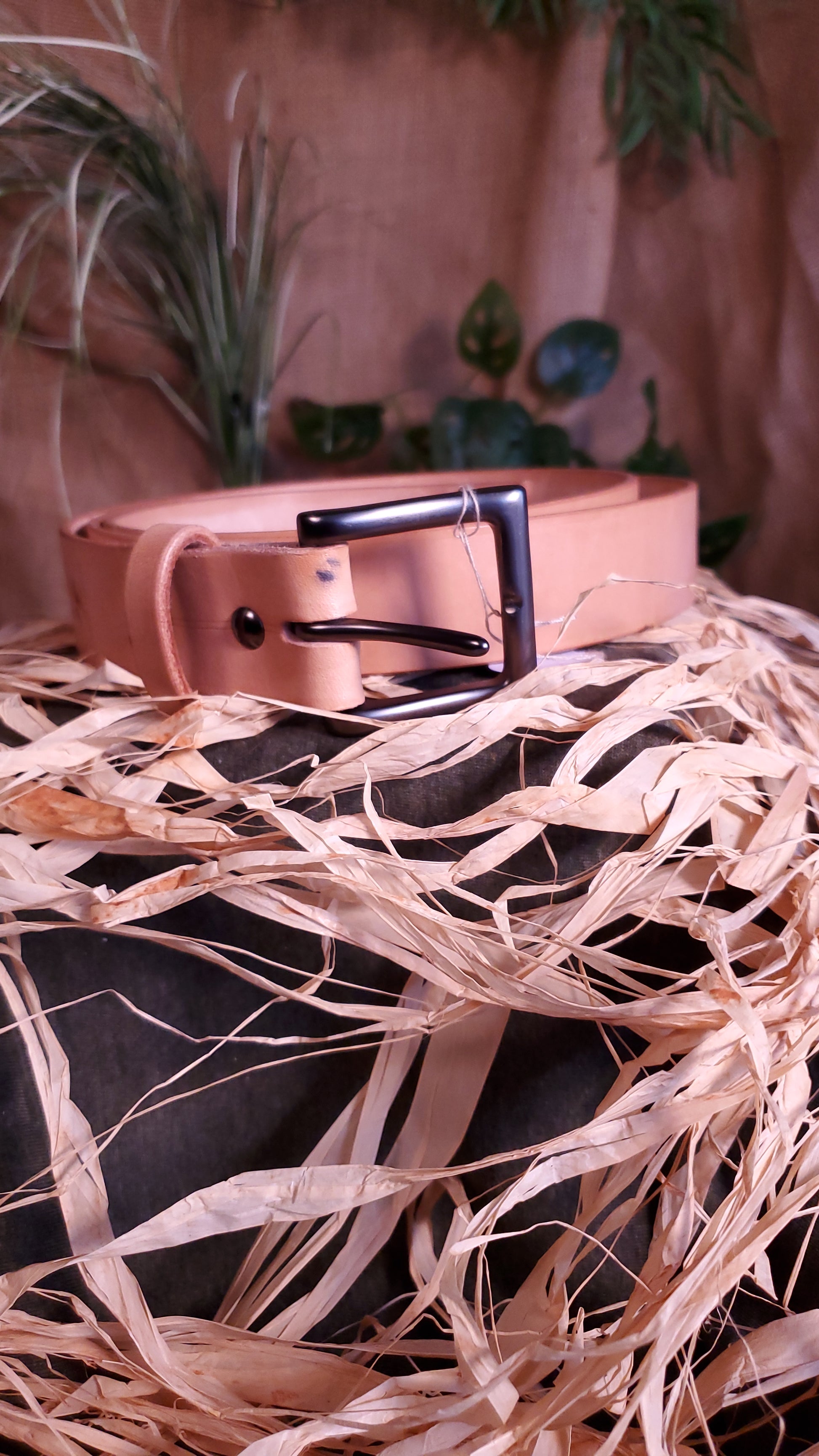 Natural colored belt with a gun metal buckle and matching hardware.