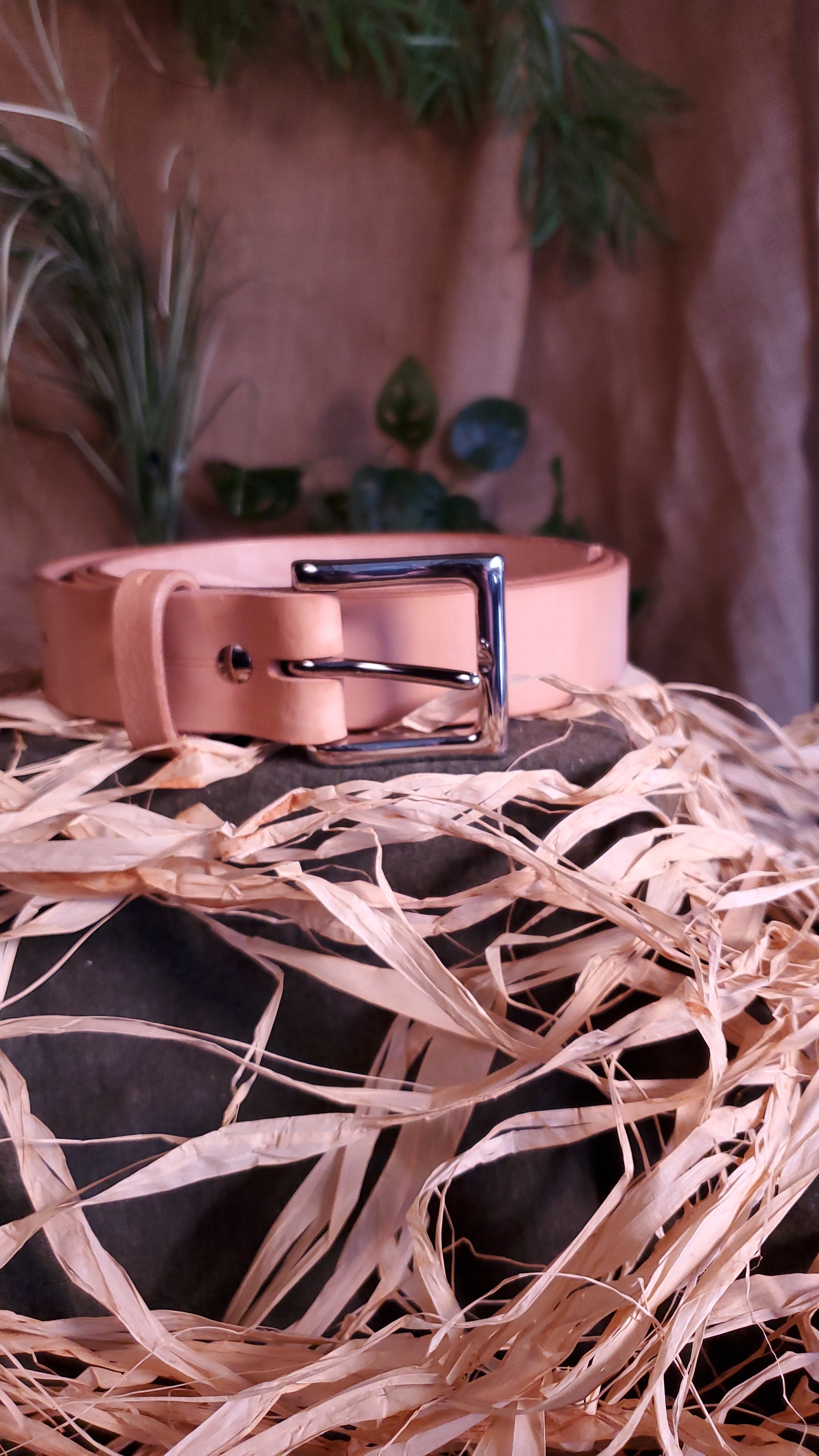 Natural colored belt with a nickel buckle and matching hardware.