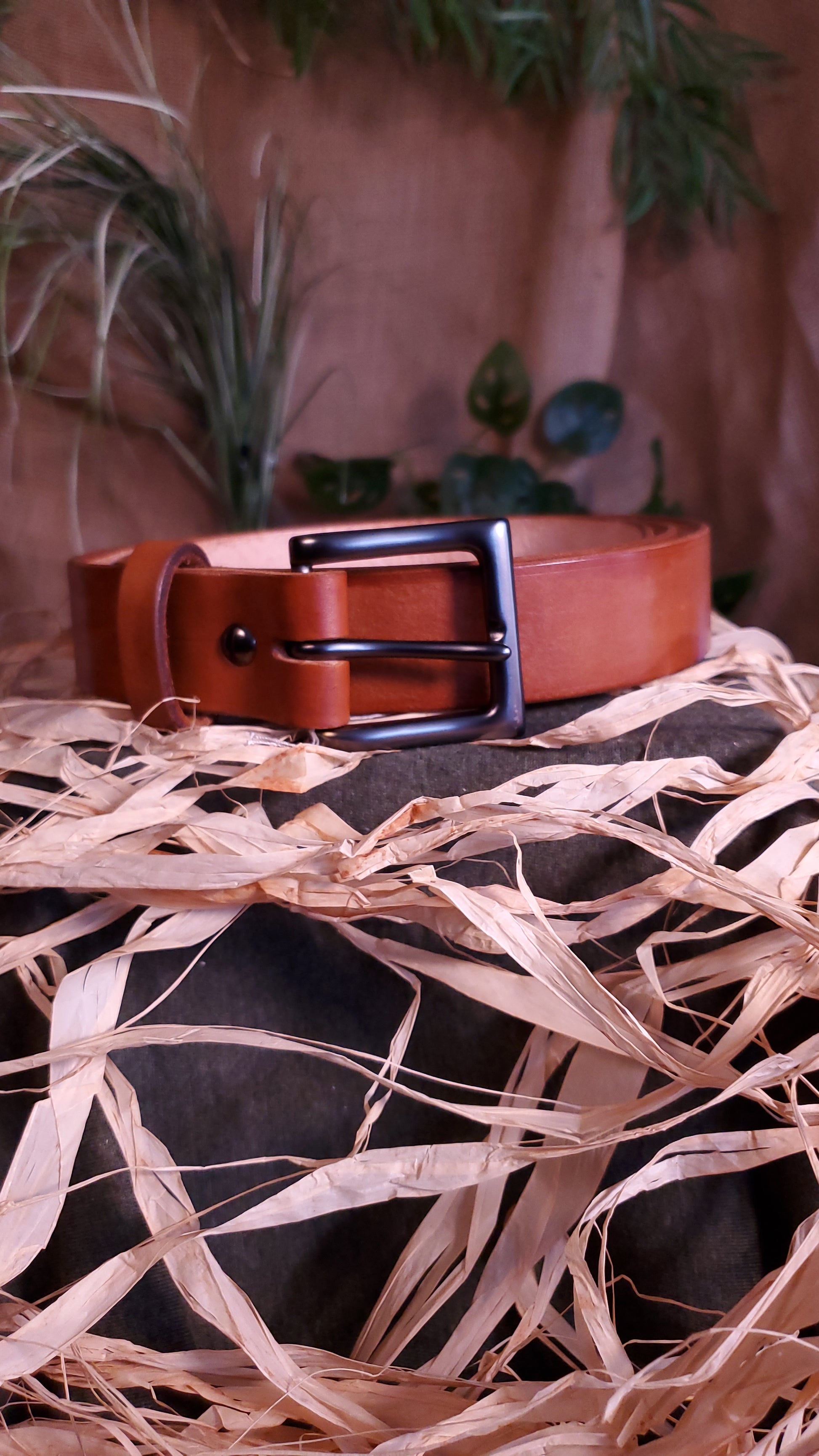 Brown colored belt with a gun metal buckle and matching hardware.