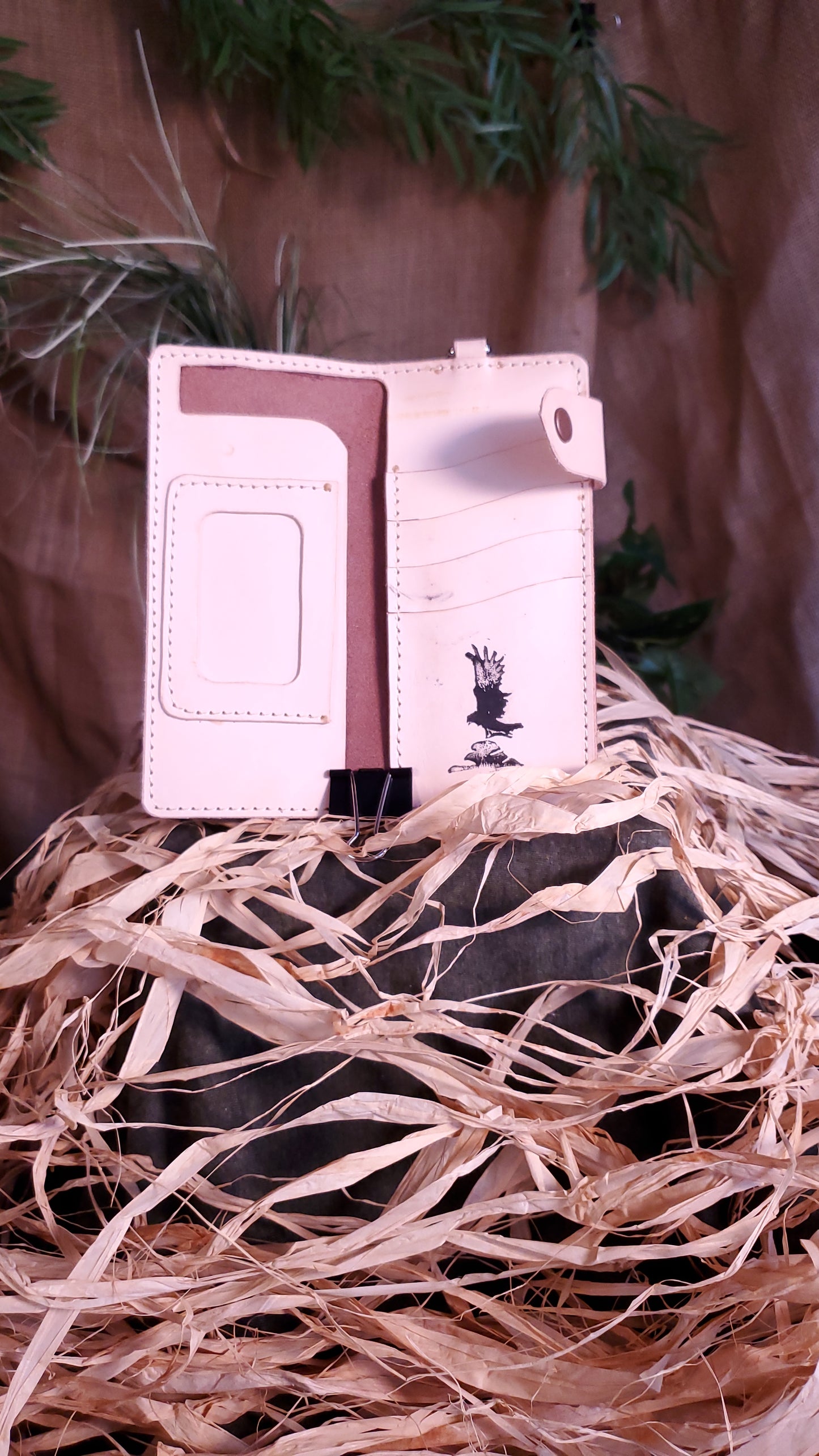 Interior of the Biker Wallet , featuring an ID pocket with window, a cash slot behind the ID pocket on the left side, four card slots on the right side. natural almost white colored interior